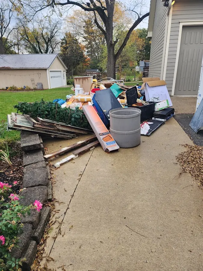Dumpster being loaded with debris for 12 Yard Dumpster Rental in Visalia